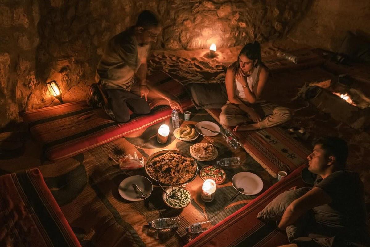 Candlelit Bedouin dinner in a cave during wild camping in Wadi Rum